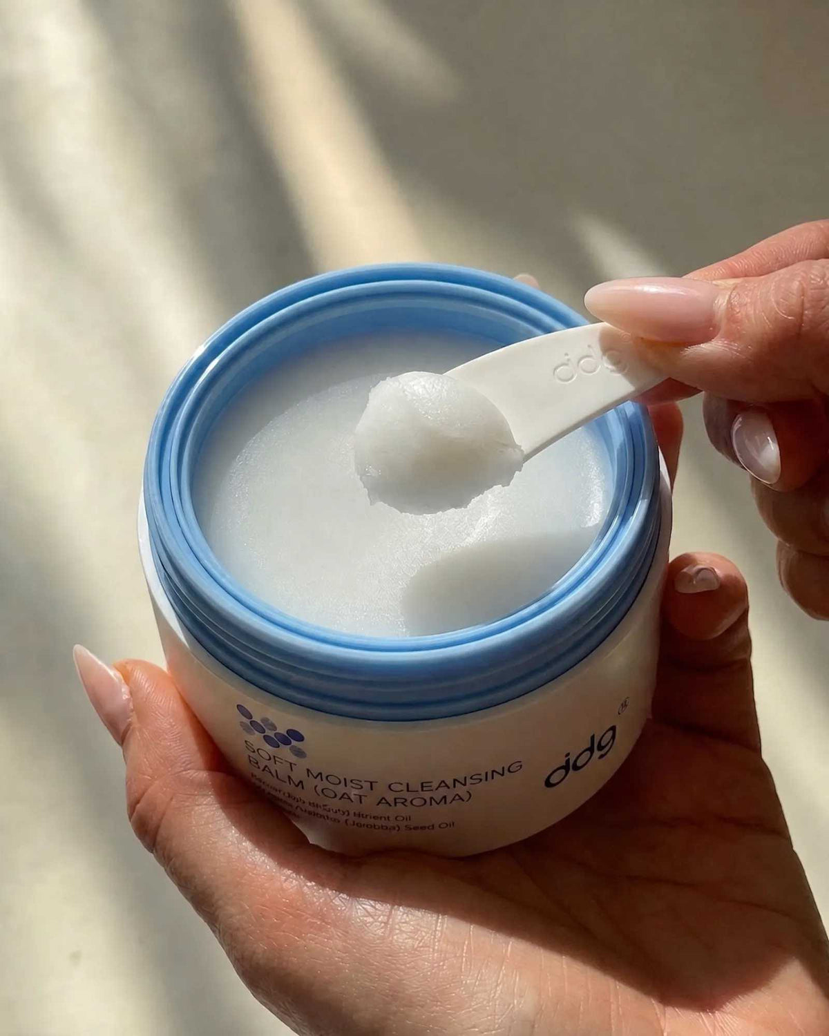 Authentic ddg cleansing balm texture lifted with the included spatula in natural window light